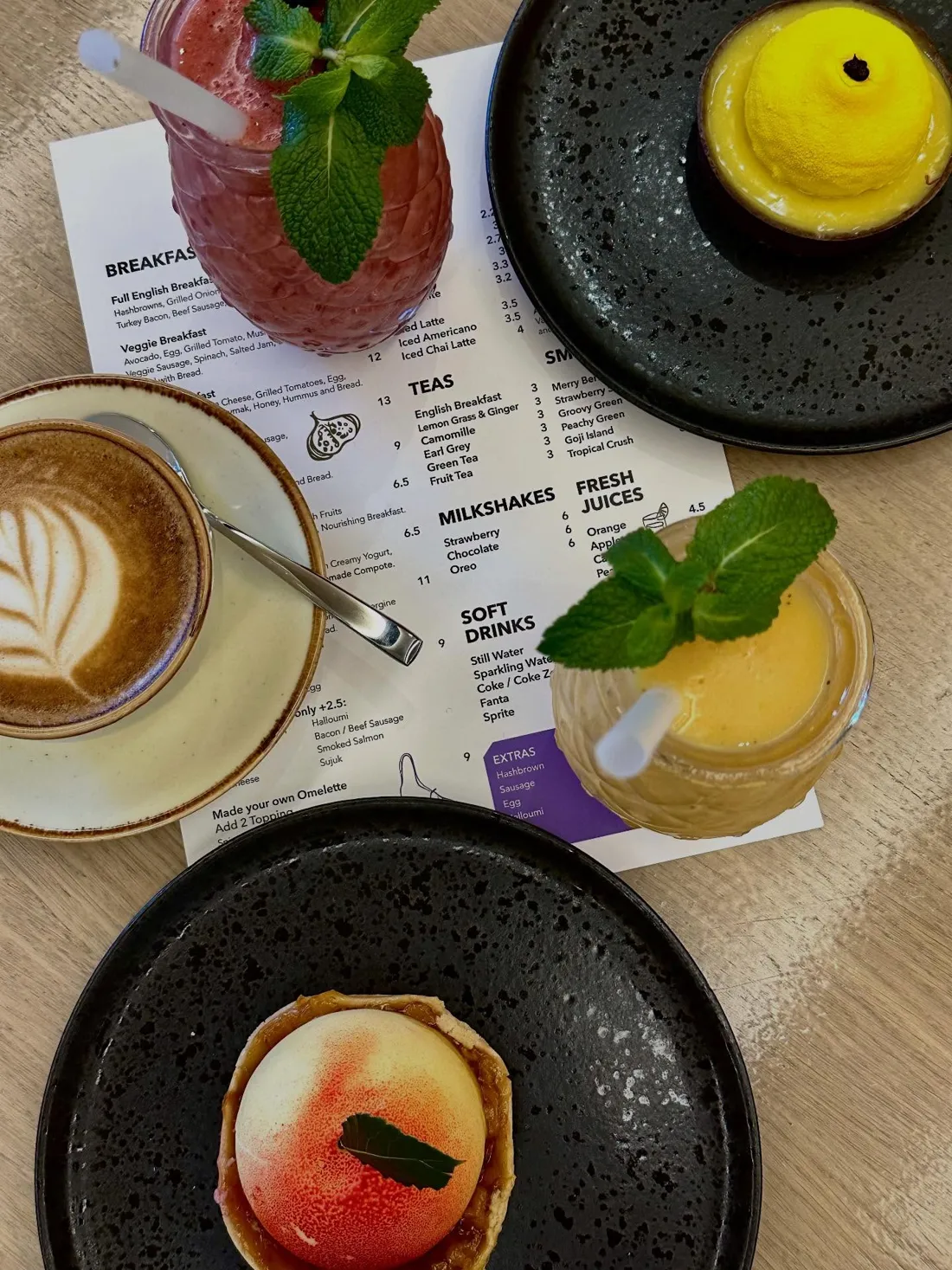 Latte, fresh juice and desserts on the table