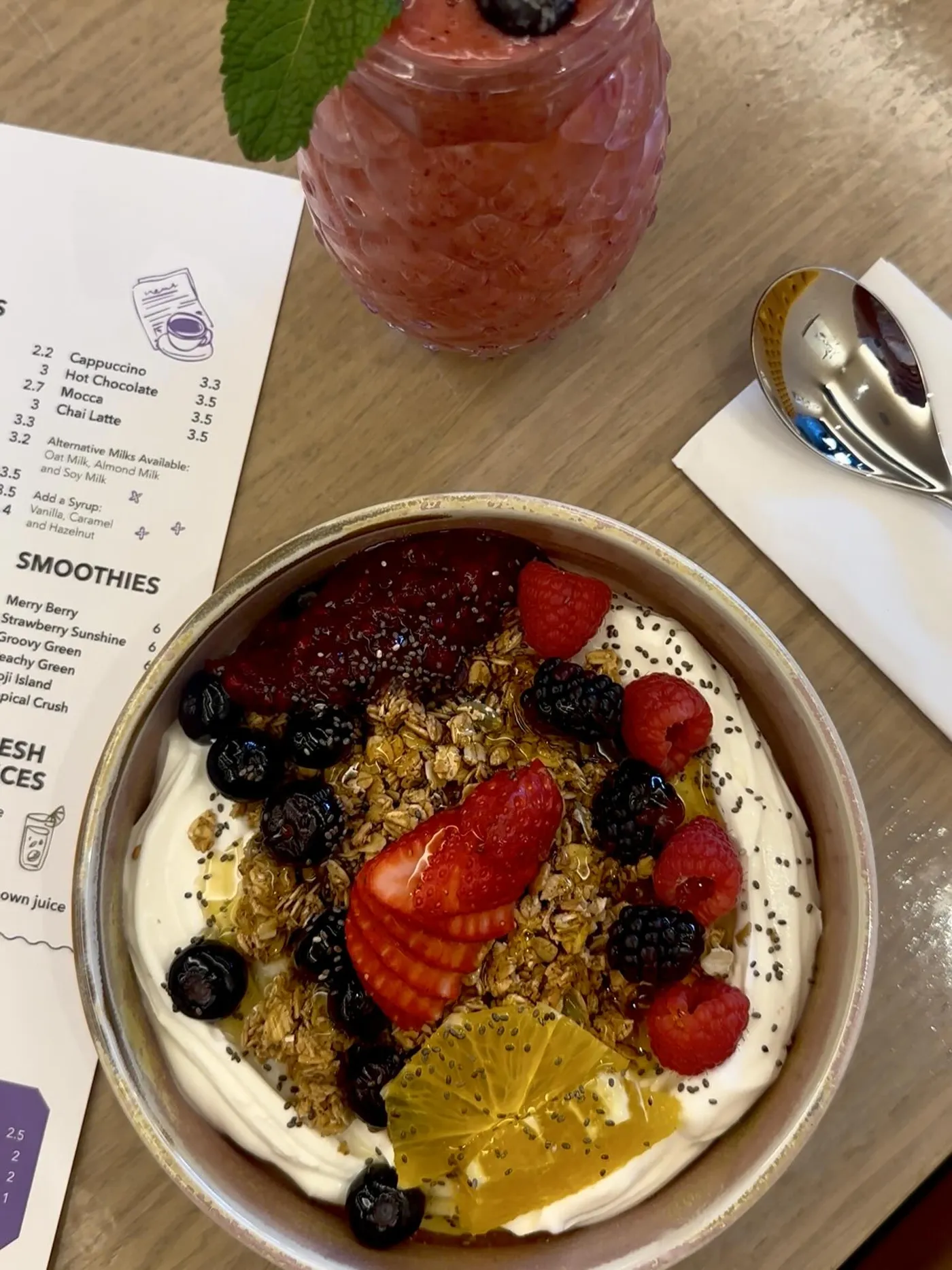 Granola with creamy yoghurt, strawberries, blackberries and blueberries